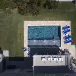 Drone-shot-of-modern-pool-wiht-huge-sunshelf.jpg