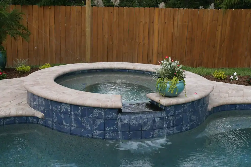 attached_spa_with_polished_black_granite_waterfall.jpg