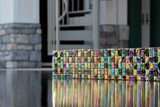 Close up of iridescent tiles on spillover wall