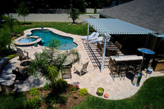 Backyard with fire pit, trellis, and pool