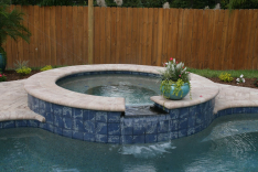 Attached spa with polished black granite waterfall