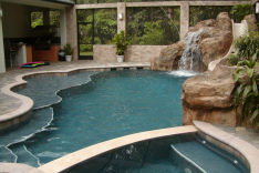 Free form pool with spa, grotto, slide, benches