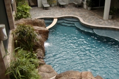Free form pool with stairs and bench seating