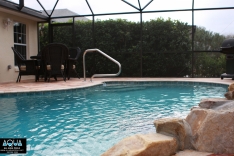 Free form pool with stairs and railing