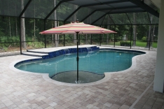 Pool with sun shelf and umbrella holder