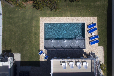 Drone shot of modern pool with huge sunshelf