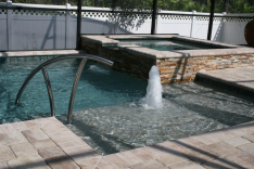 Custom pool with sunshelf and spa
