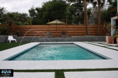 Modern backyard with rock walls and pool