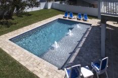 New Smyrna Beach custom pool with sun shelf and paver deck