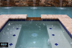 Attached spa with blue tile accents