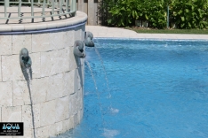 Curved wall with water spouts